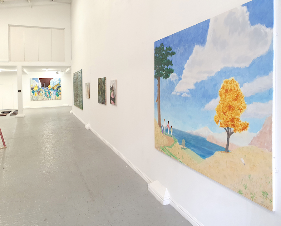 Paintings on a gallery wall, receding sharply. Closest painting is